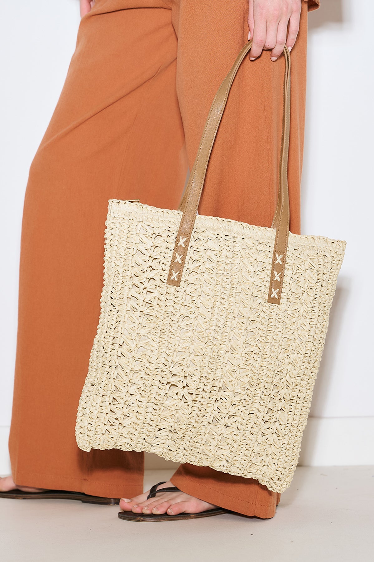Beige patterned straw shoulder bag with faux leather straps, view 1