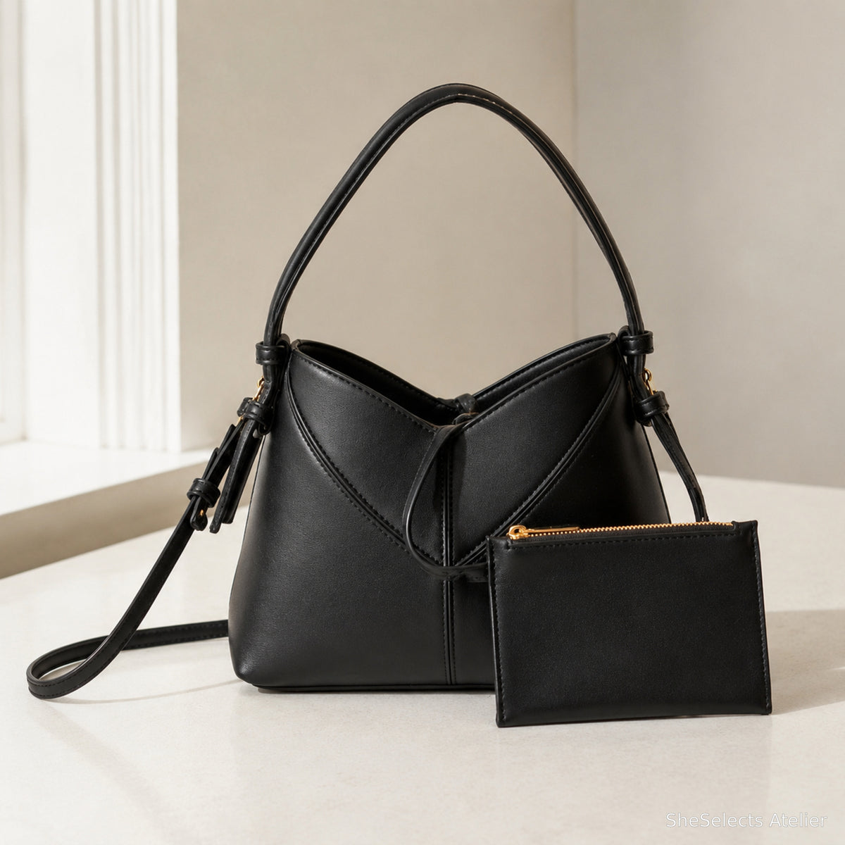 Black vegan leather oval hobo shoulder bag with matching zip pouch