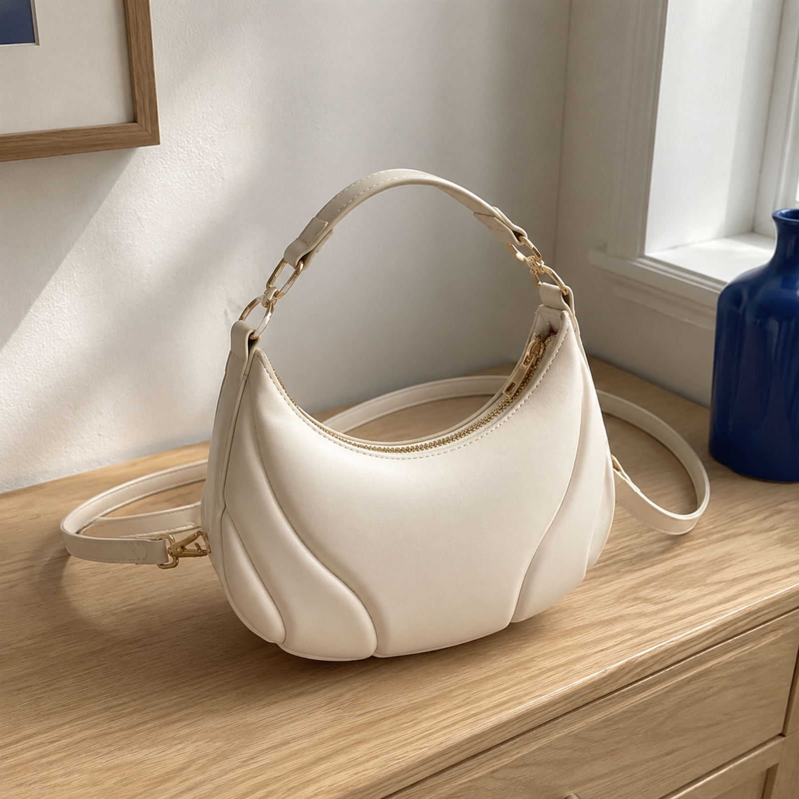 White crescent hobo shoulder bag with sculpted petal seams