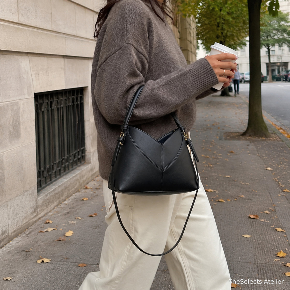 Woman carrying black vegan leather hobo bag on an autumn city walk
