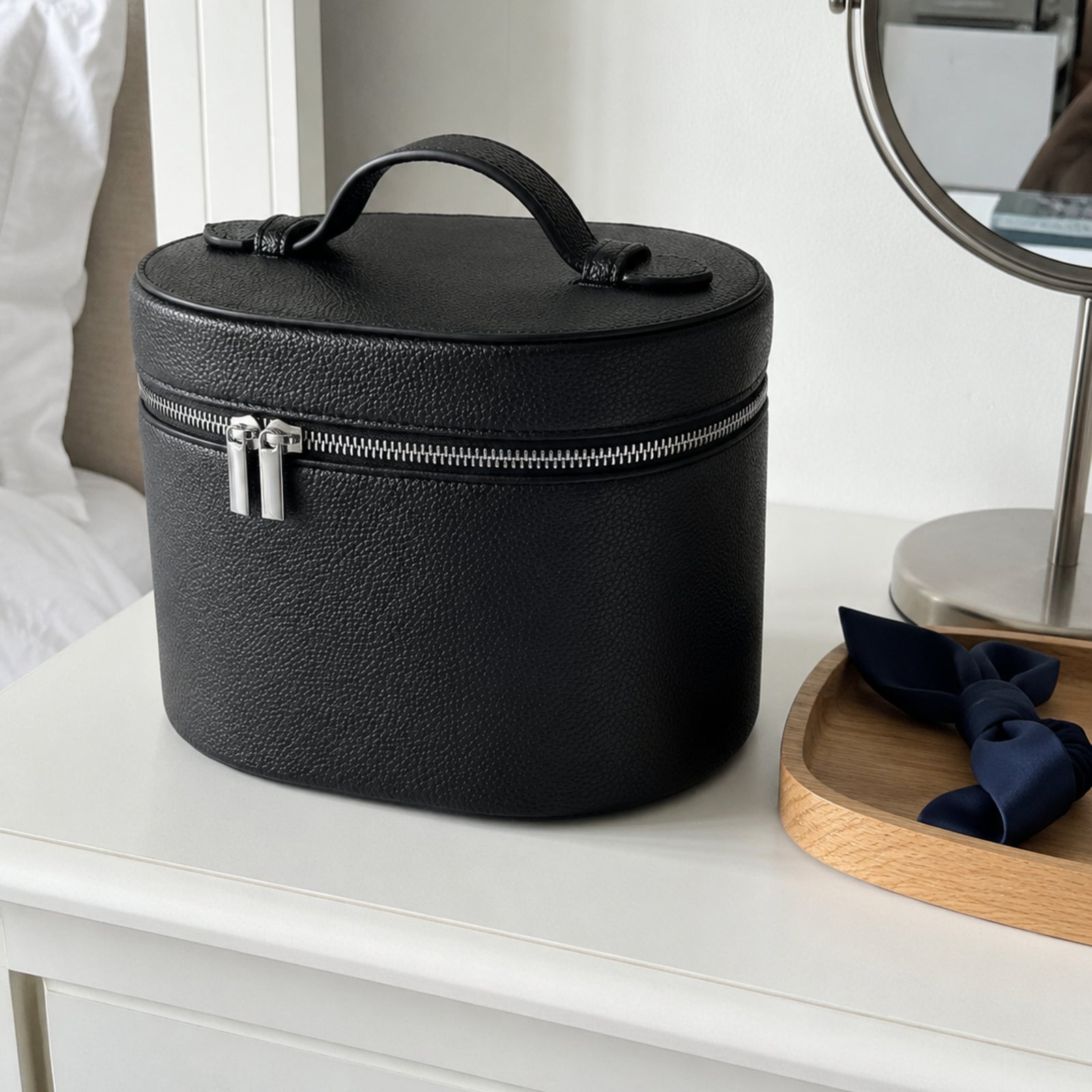 Black lychee-grain cosmetic organizer on a fresh white bedroom vanity