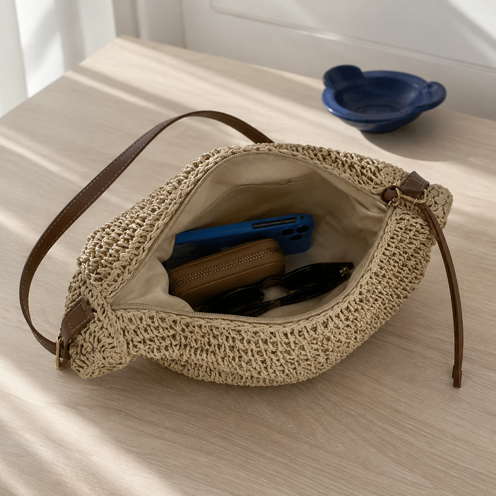 Beige woven shoulder bag opened to show its fabric-lined interior