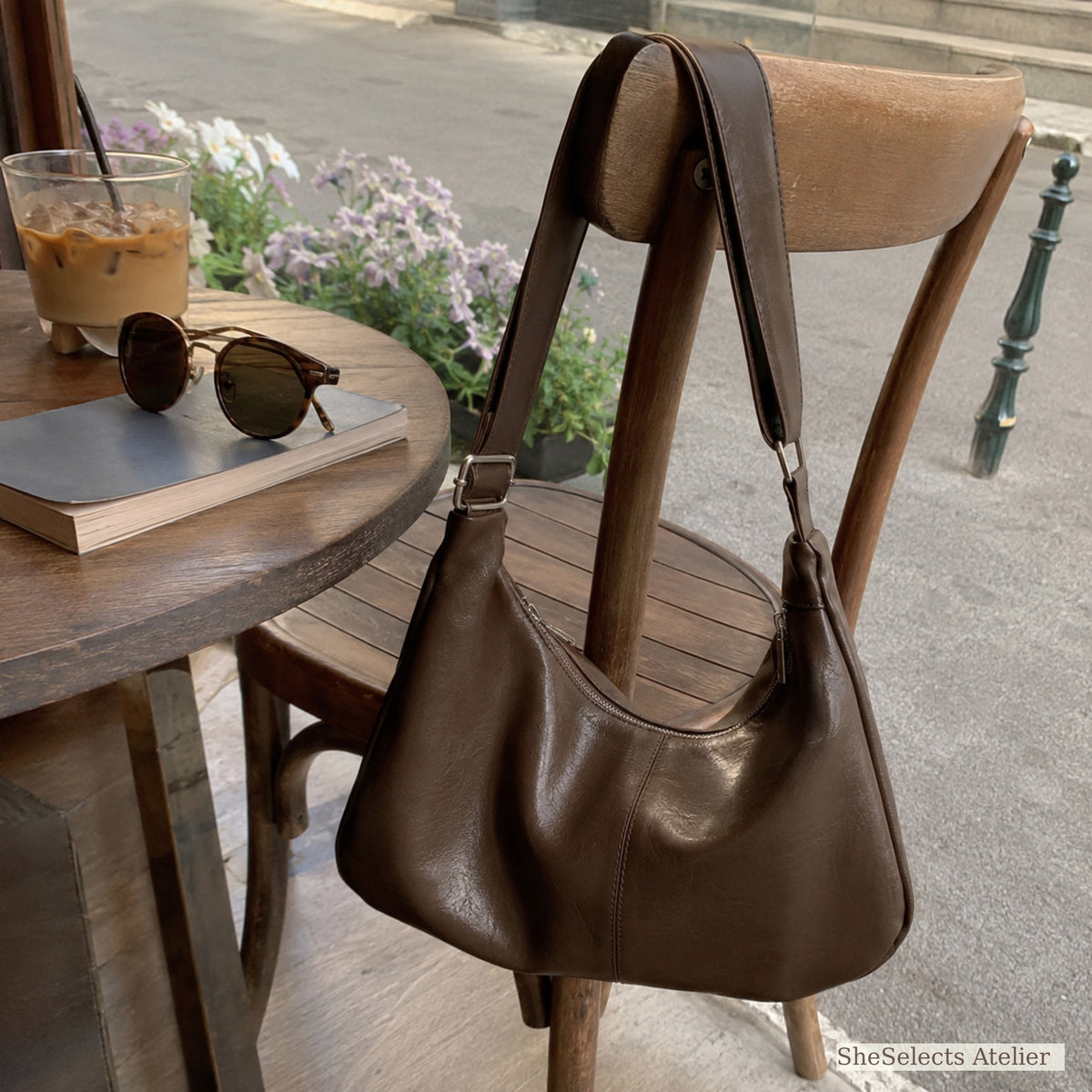Brown slouchy shoulder purse at a sunny sidewalk cafe