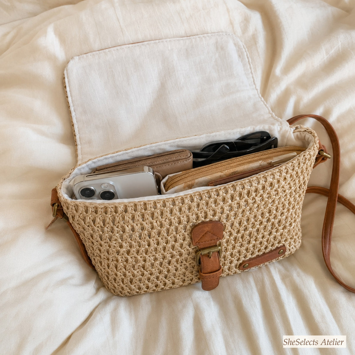 Open beige straw crossbody bag showing cotton lining and daily essentials