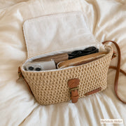 Open beige straw crossbody bag showing cotton lining and daily essentials