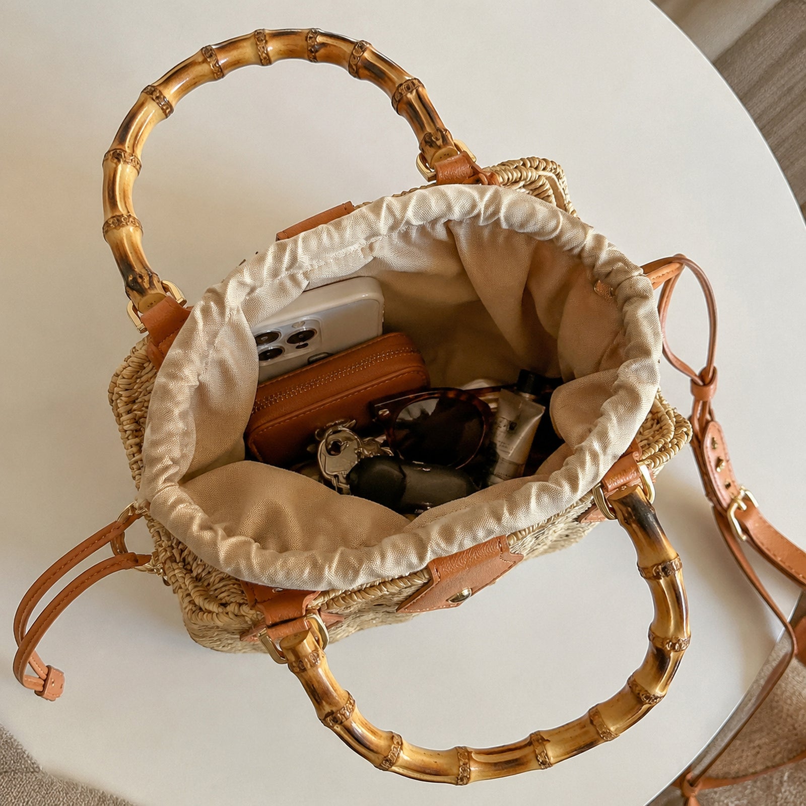 Open bamboo handle bag showing gathered fabric lining and room for everyday essentials