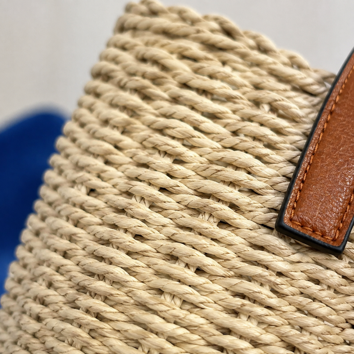 Close-up of the hand-crocheted paper-straw weave and handle edge