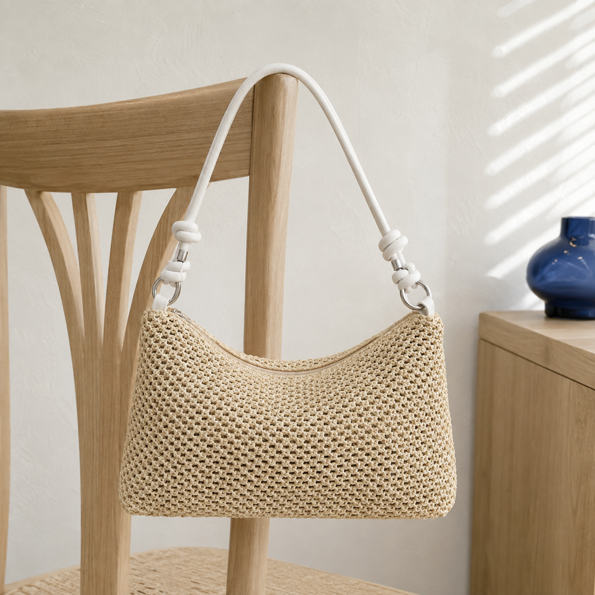 Natural woven straw hobo with white handle and secure zip top