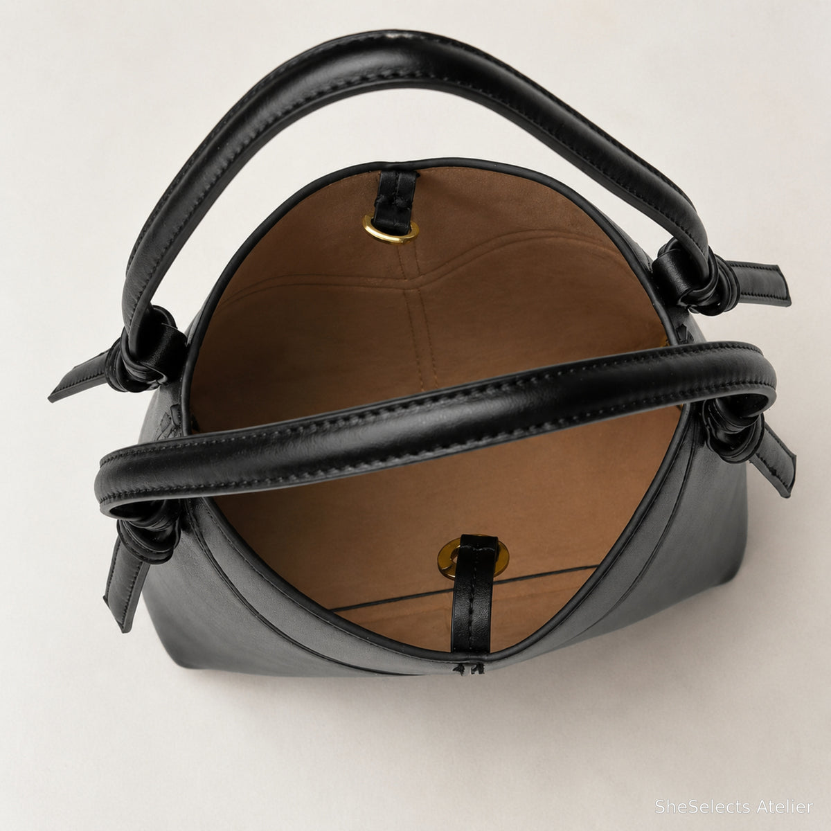 Brown nylon interior of black vegan leather hobo shoulder bag