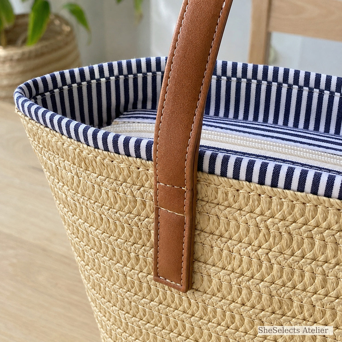 Close-up of brown handle, striped trim and woven straw texture