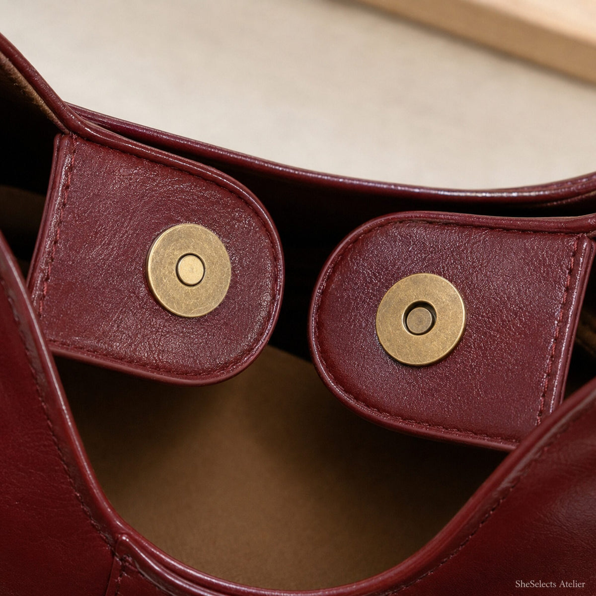 Close-up of magnetic snap closure on Wine Red vegan leather tote