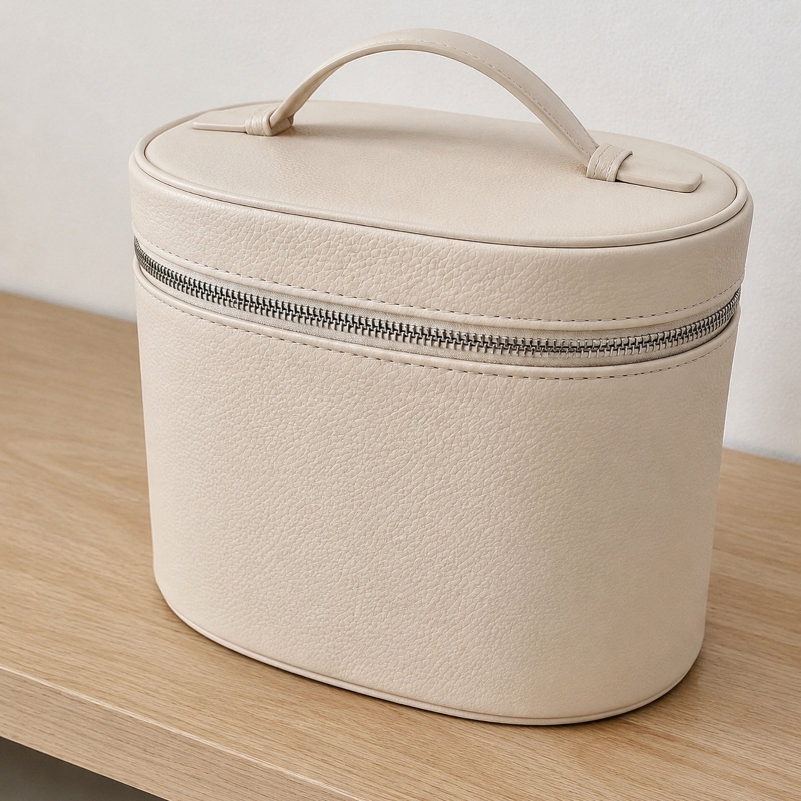 Beige makeup organizer shown from the rear with rounded depth, piping, and top handle