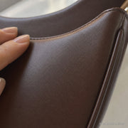 Minimalist Crescent Shoulder Bag, Small Vegan Leather Purse with Gold Chain Detail | texture brown | SheSelects Atelier
