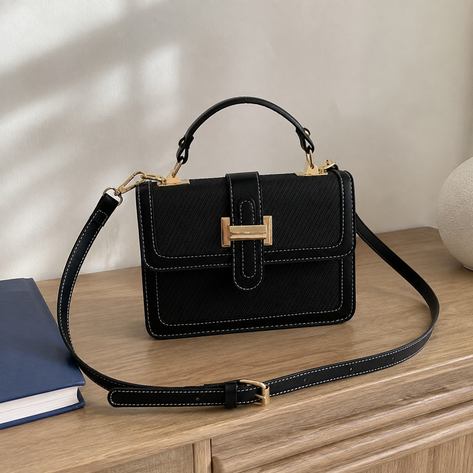 Black textured contrast-trim petite tote bag on pale oak