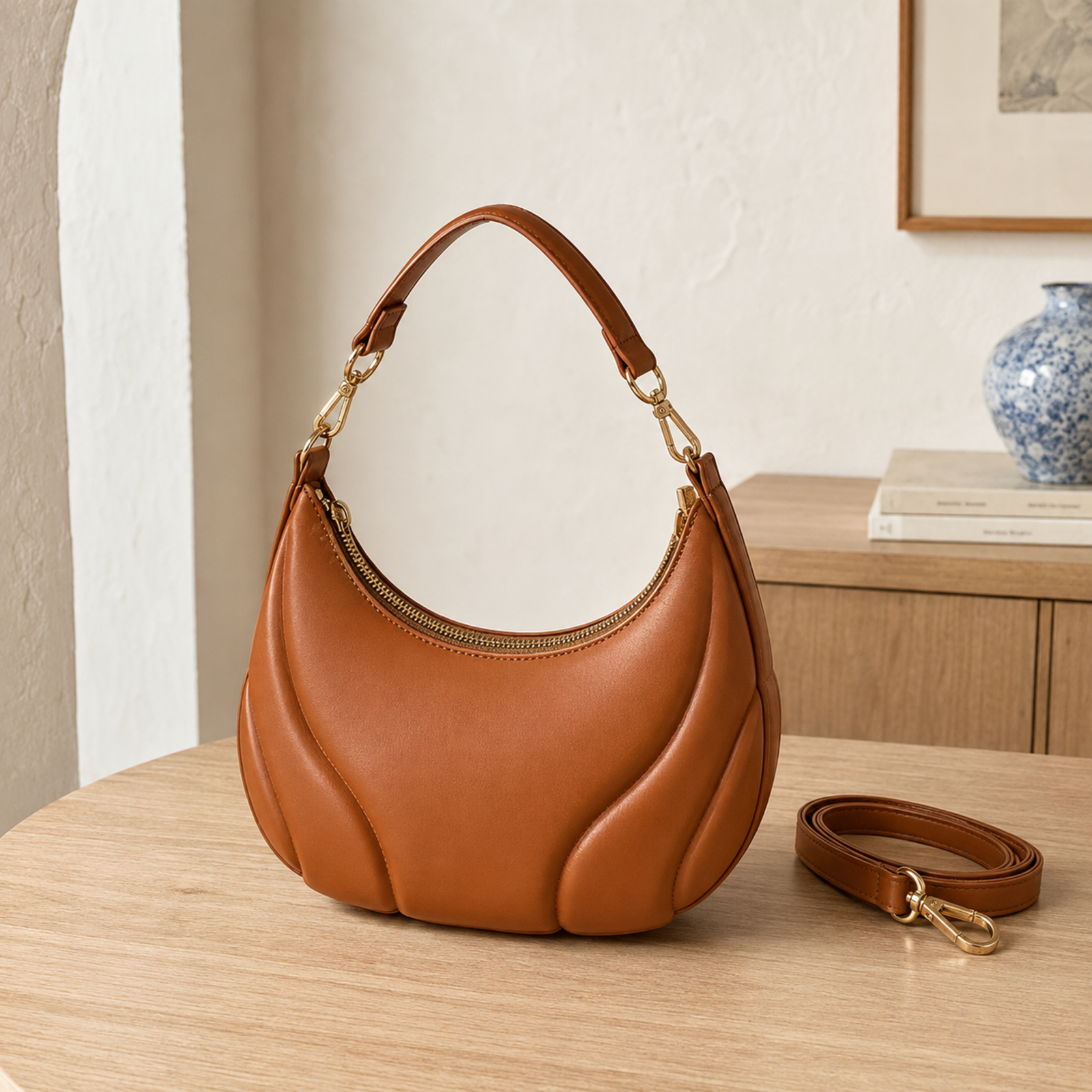 Brown crescent hobo bag with short chain-trim handle