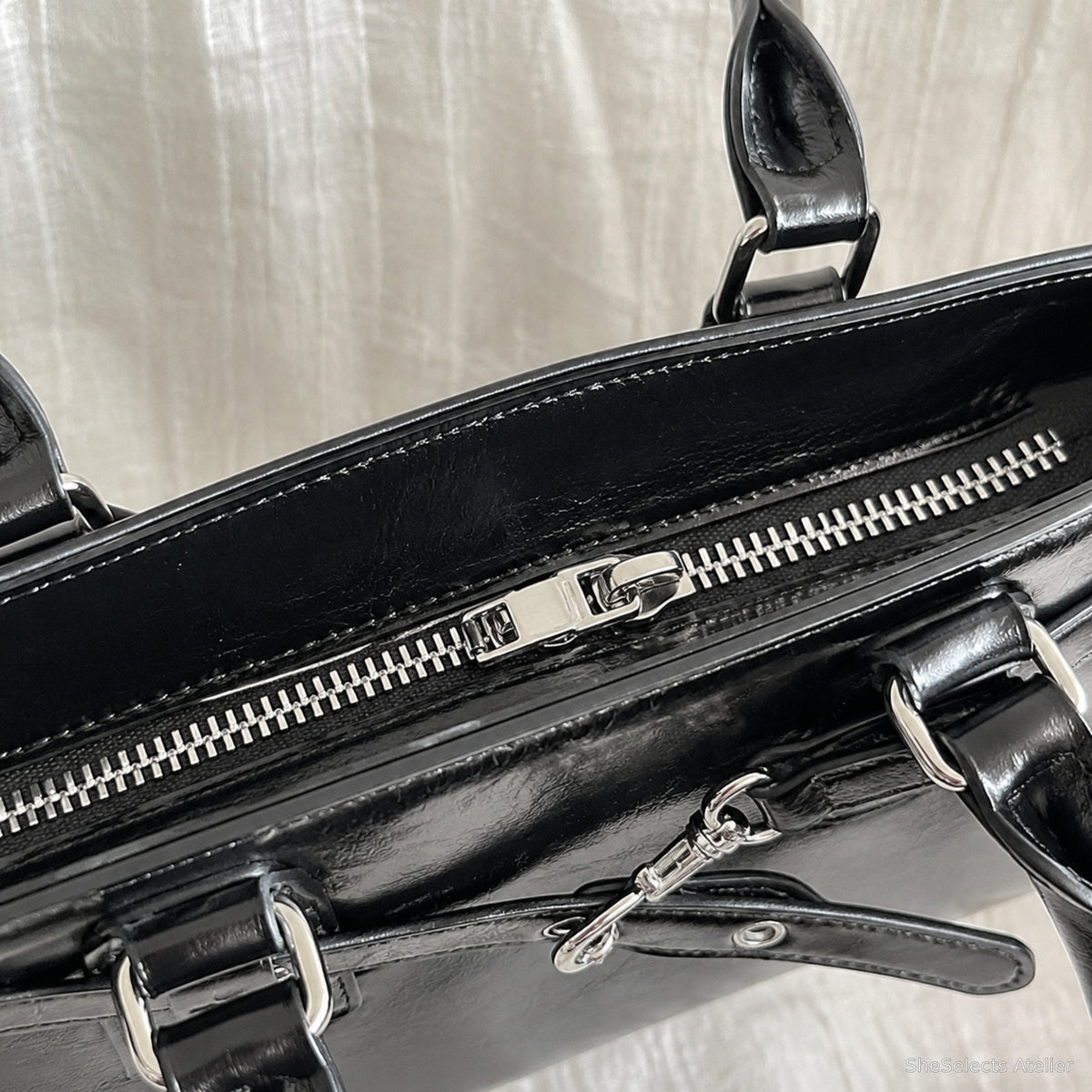 Close-up of the black baguette bag top zipper