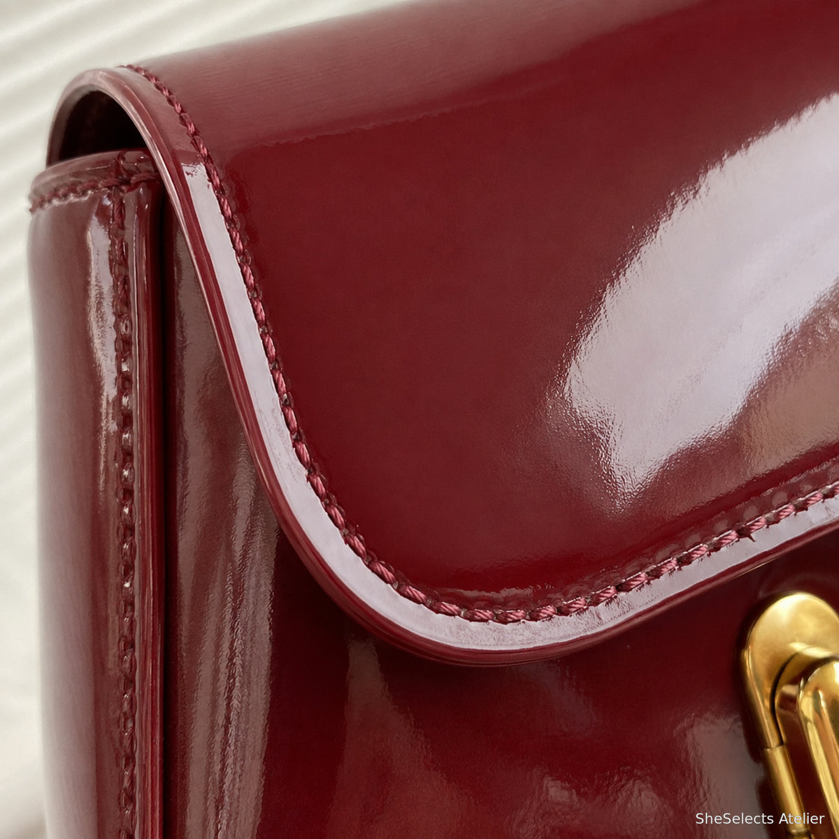 Close-up of Wine Red glossy vegan leather flap edge and stitching