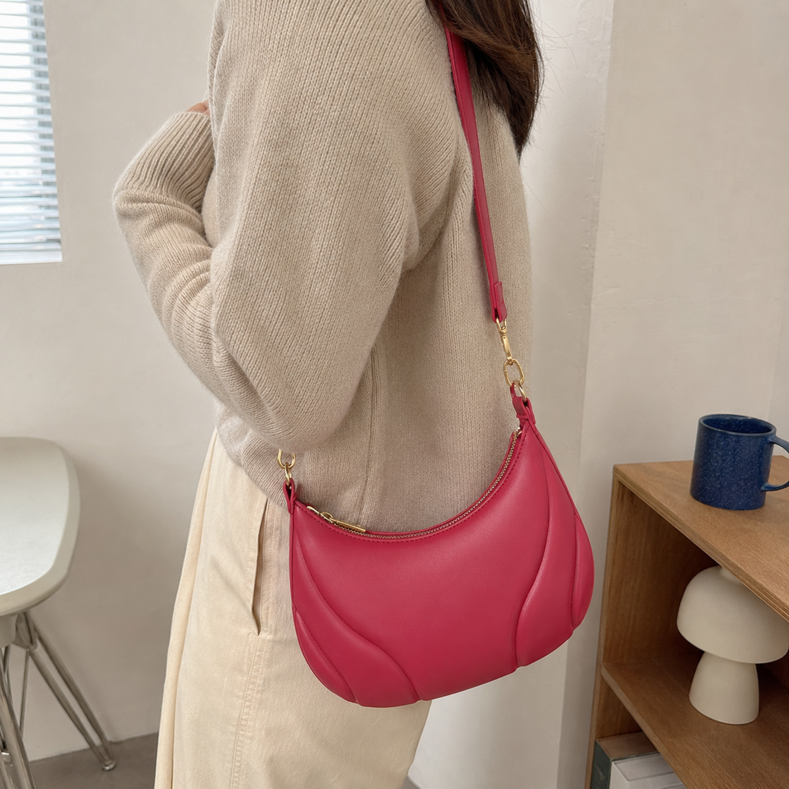 Rose red crescent shoulder bag worn crossbody