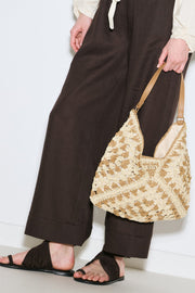 Beige patterned straw handbag with snap closure and inner pocket, view 1