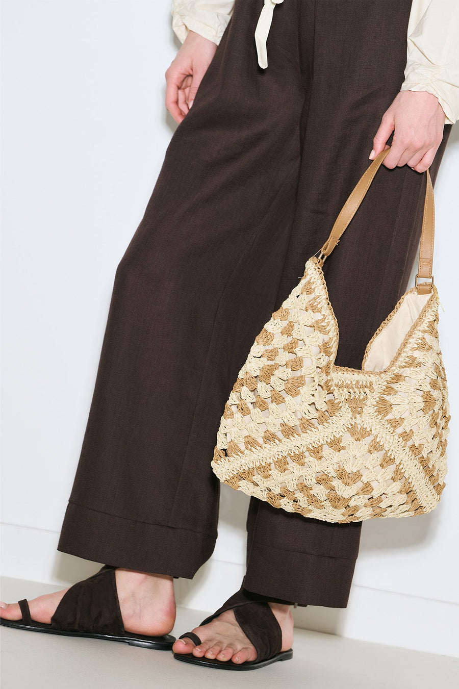 Beige patterned straw handbag with snap closure and inner pocket, view 1