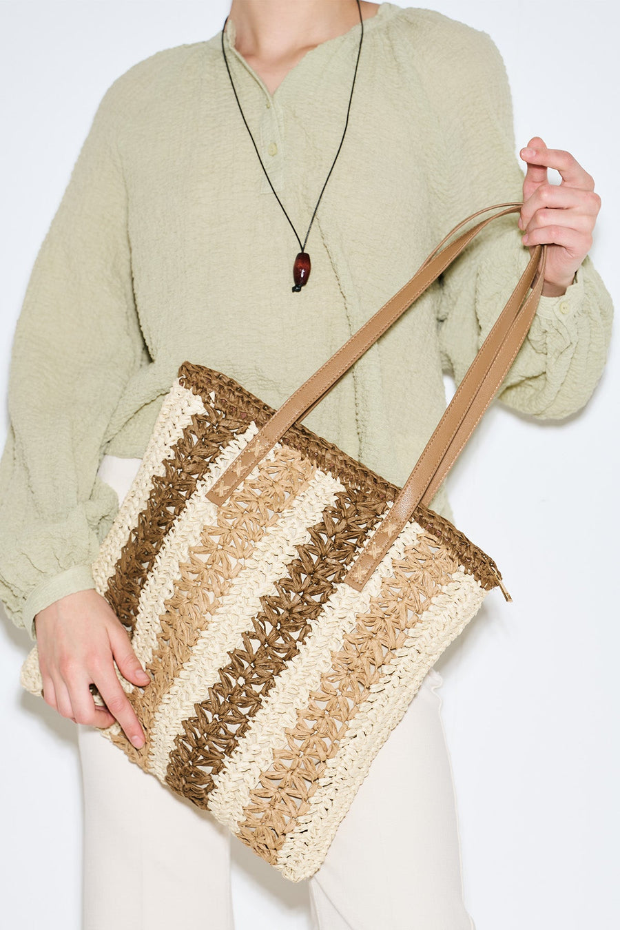 Beige striped straw shoulder bag with faux leather strap, view 1