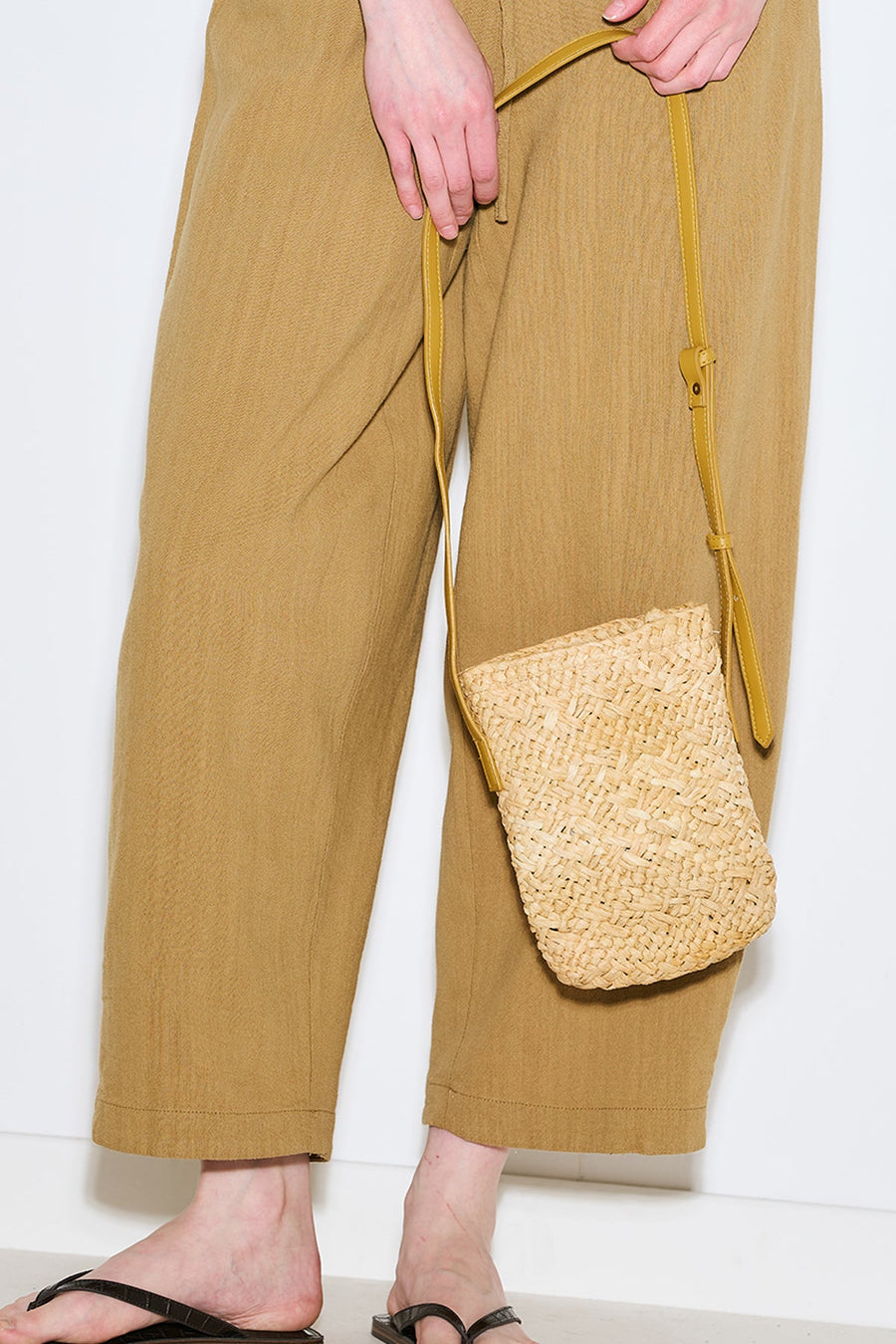Beige mini straw basket bucket bag with drawstring closure, view 1