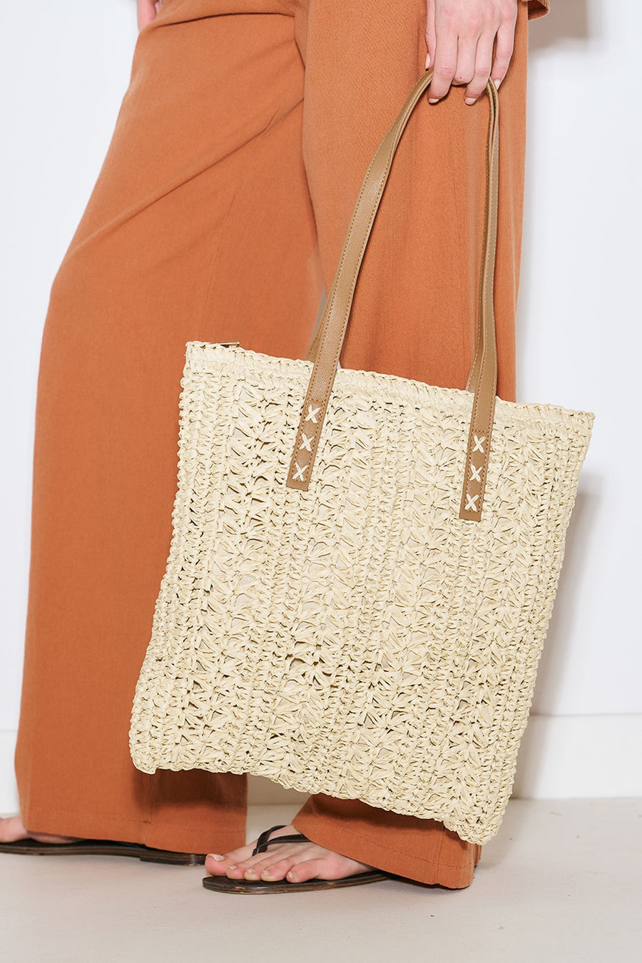 Beige patterned straw shoulder bag with faux leather straps, view 1