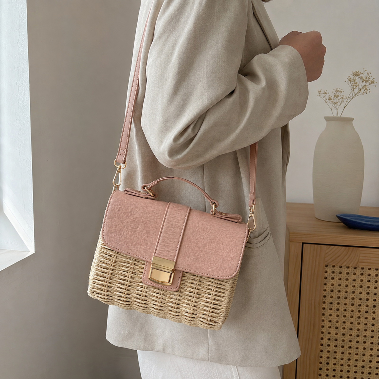 Khaki woven straw crossbody bag worn on the shoulder