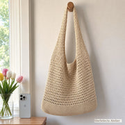 Beige knit shoulder bag beside an iPhone for visual size reference