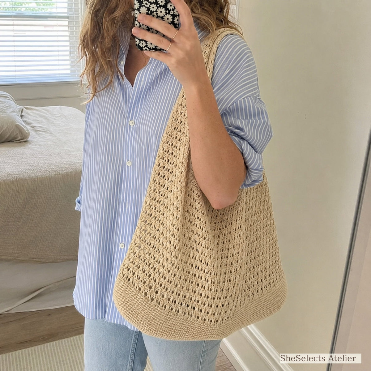 Customer mirror selfie wearing a beige hollow knit shoulder bag