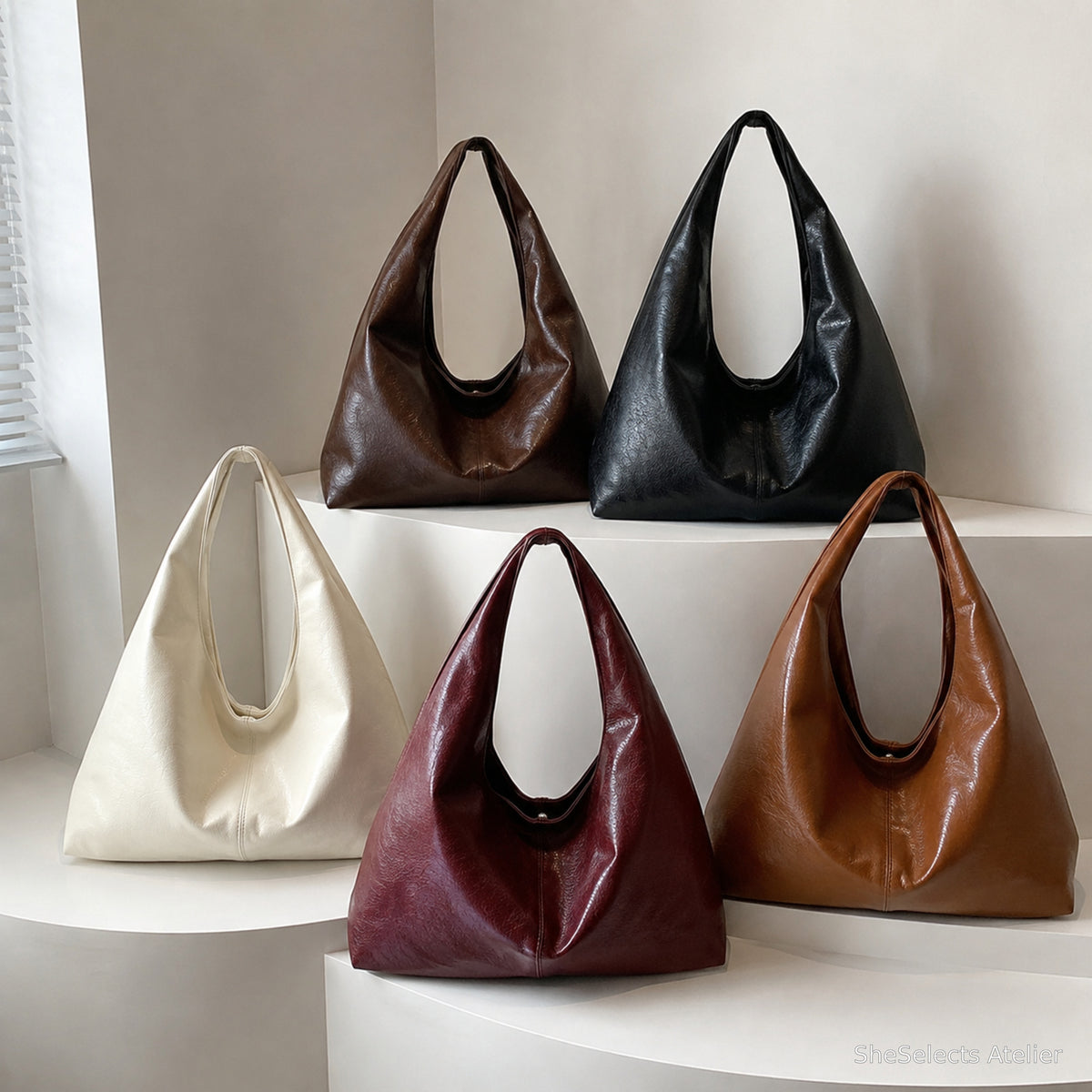 Slouchy hobo bags displayed in Coffee, Black, White, Red, and Brown