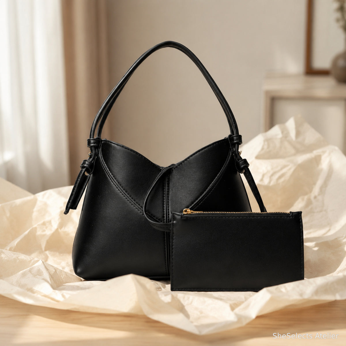 Black vegan leather hobo bag and pouch presented as a thoughtful gift