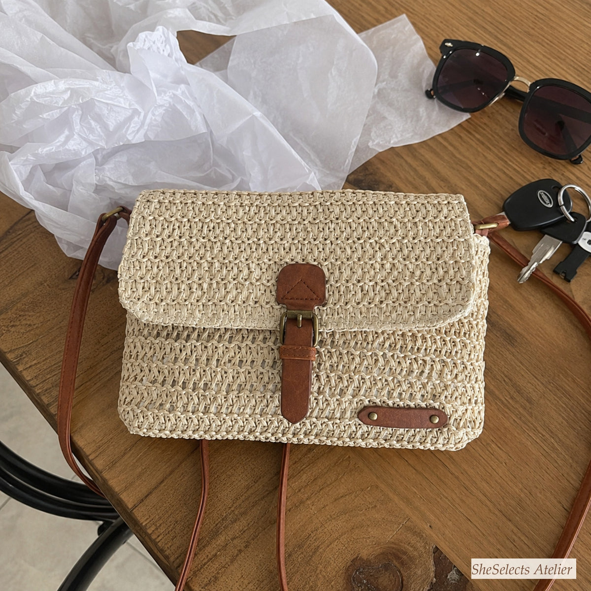 Customer home photo of a beige straw bag on a wooden table
