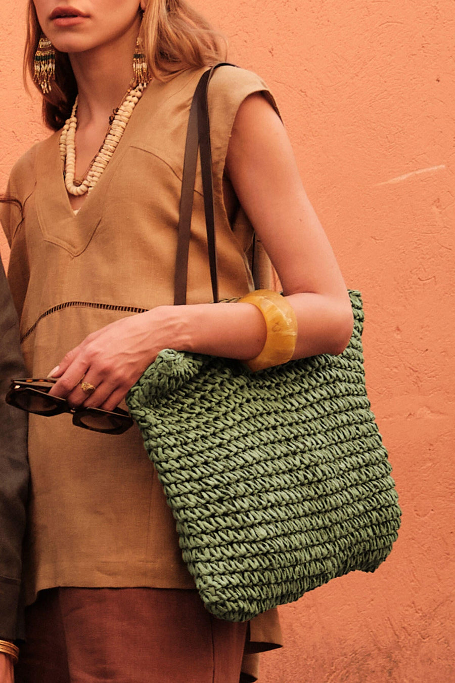 Green woven straw shoulder bag with faux leather strap and zip closure, view 1