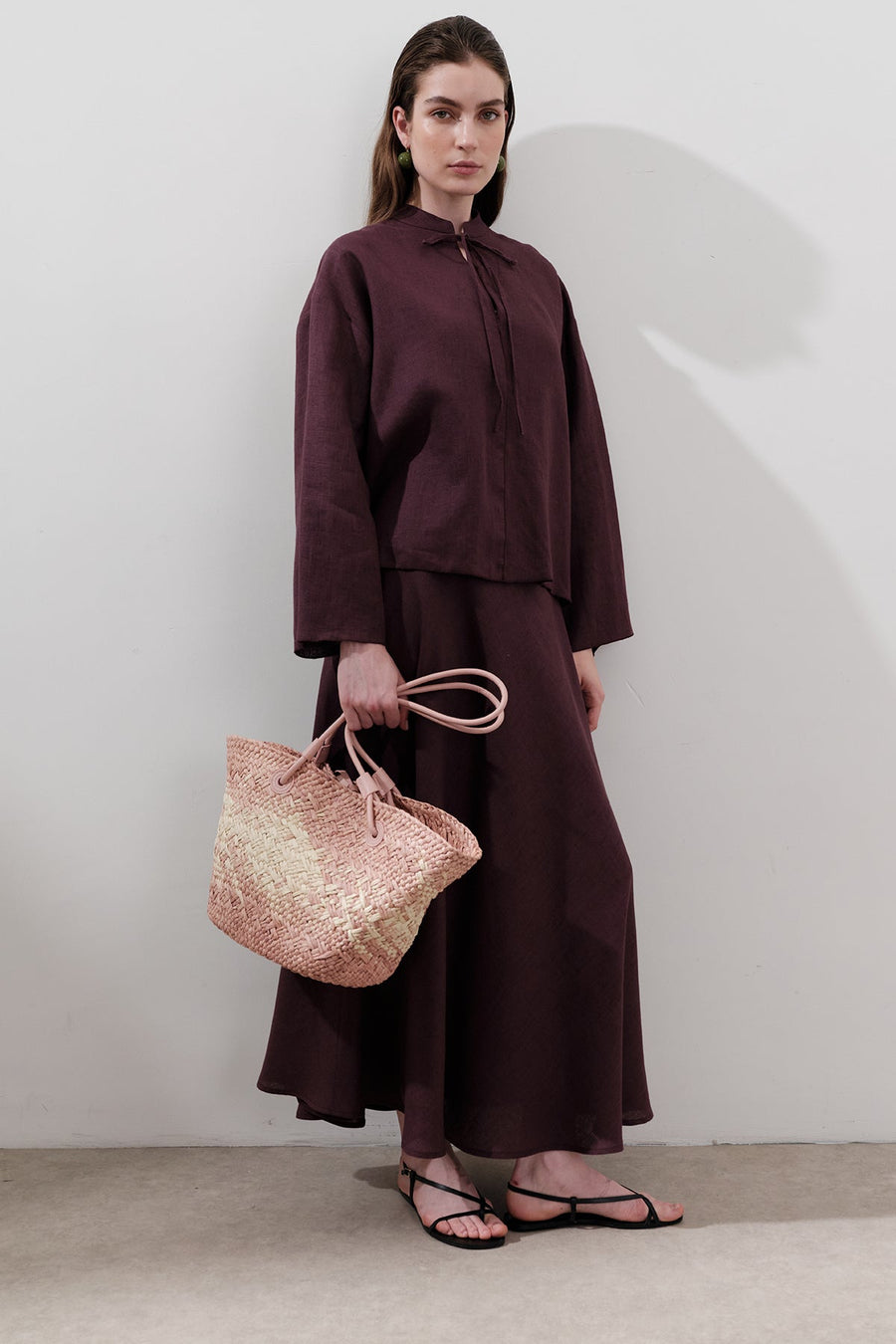 Pink straw shoulder bag with faux leather strap and contrast stitching, view 1