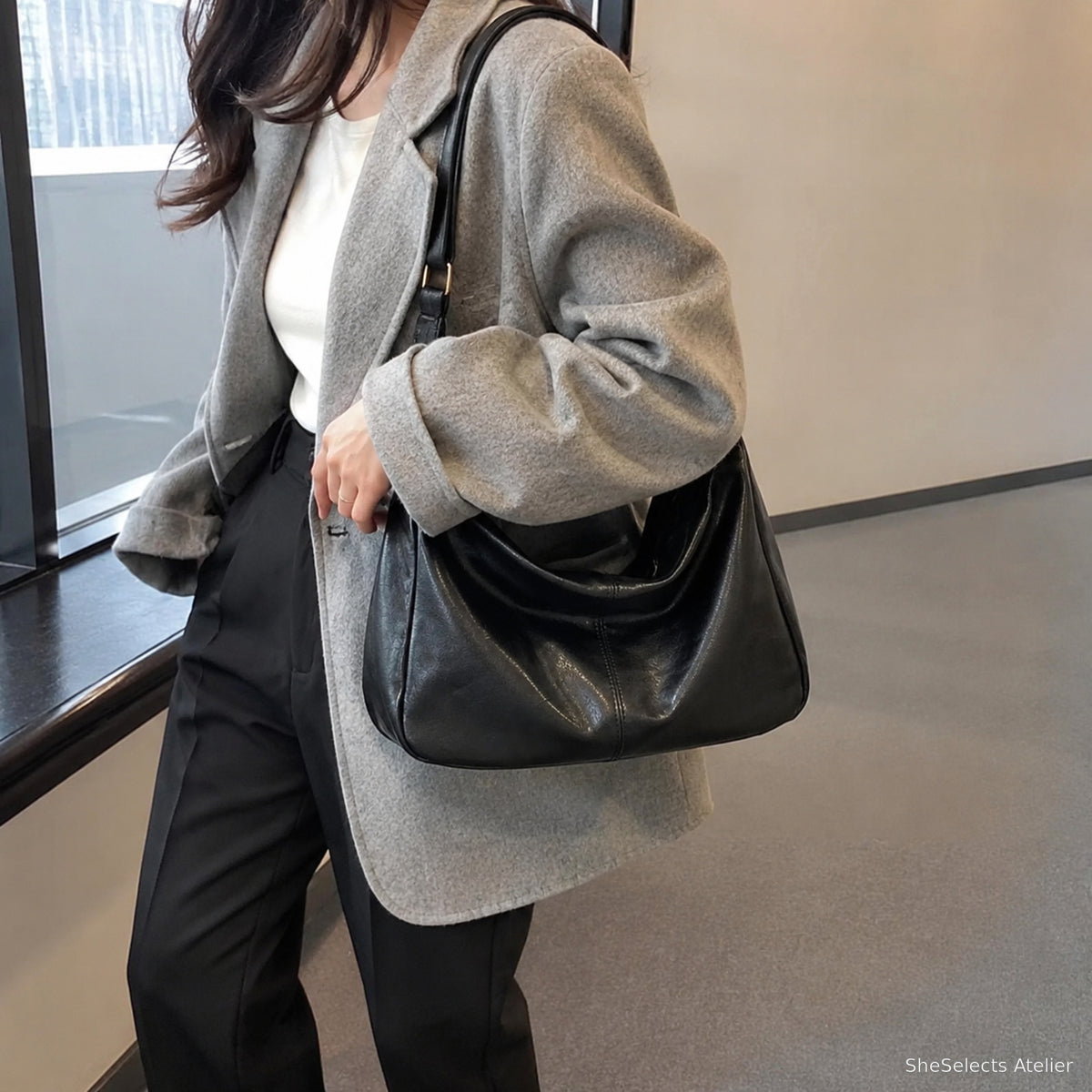 Black slouchy hobo shoulder bag styled with a grey blazer for work