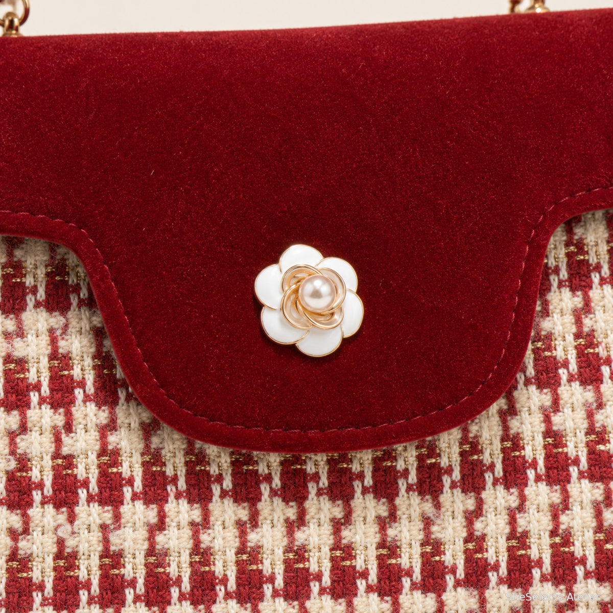 White flower clasp and red cream woven front close up