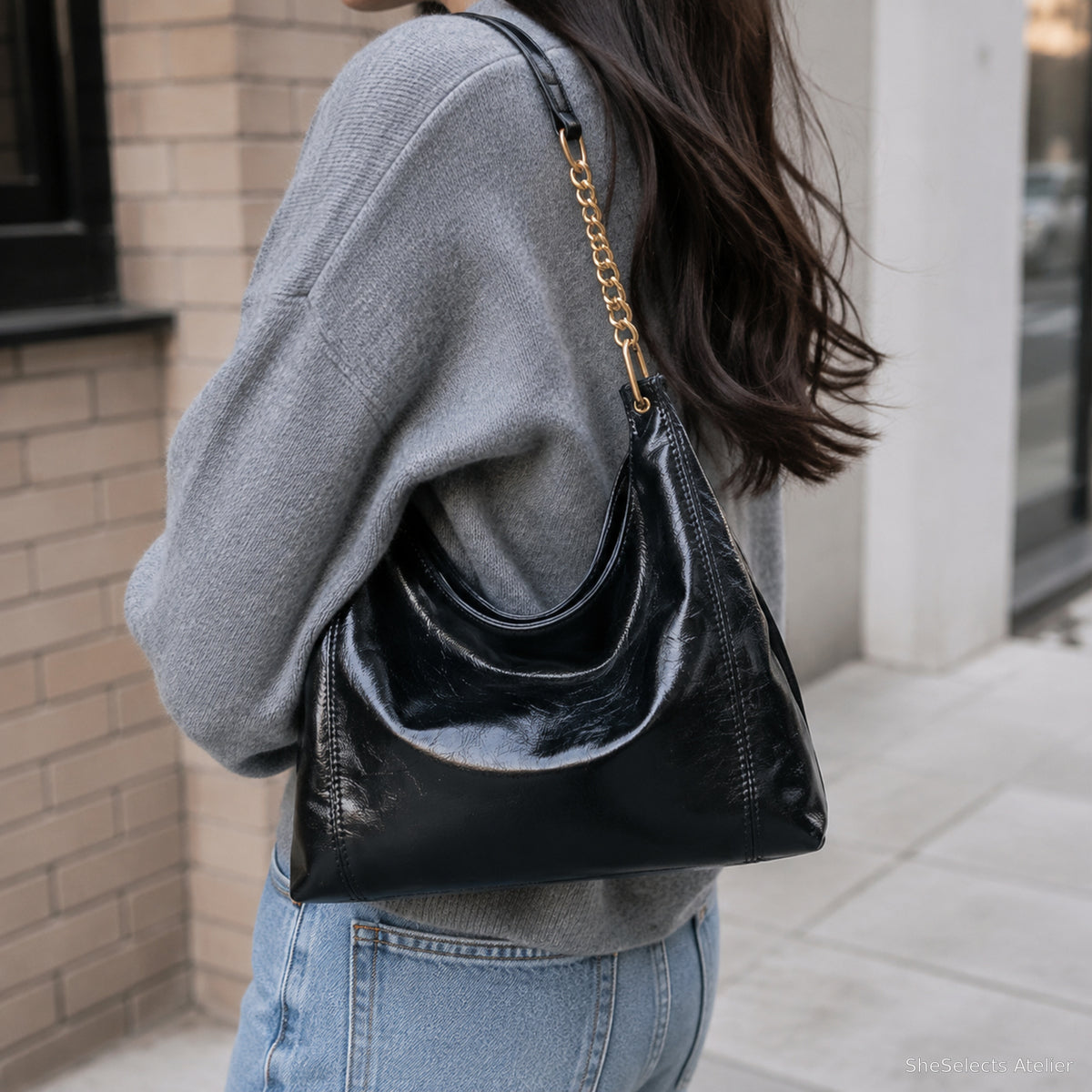 Black glossy chain hobo bag in a casual street style
