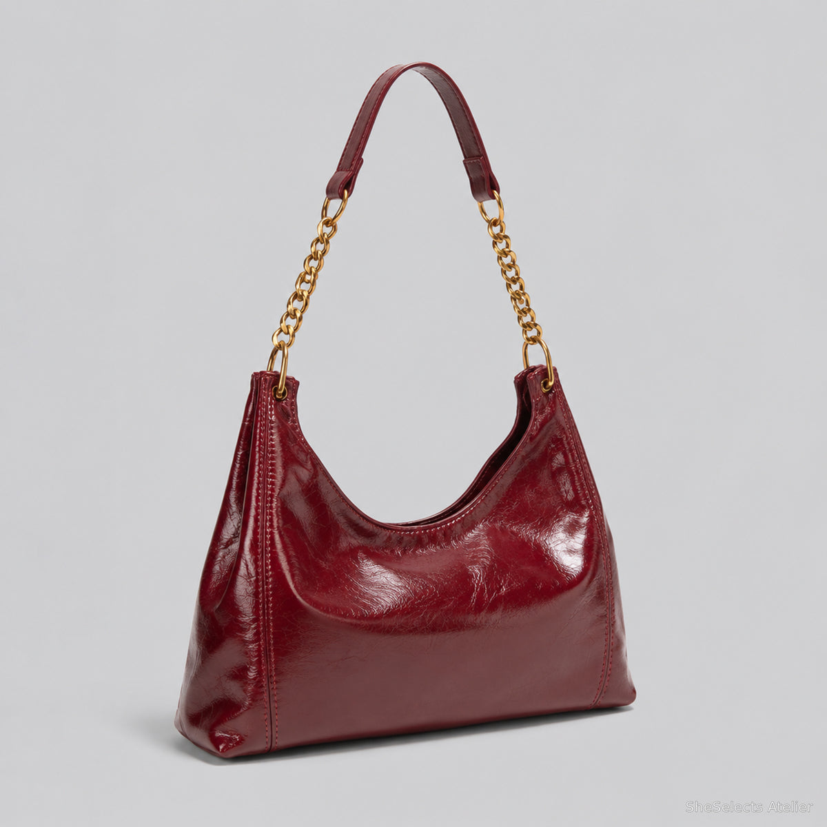 Burgundy glossy hobo bag shown from an alternate angle