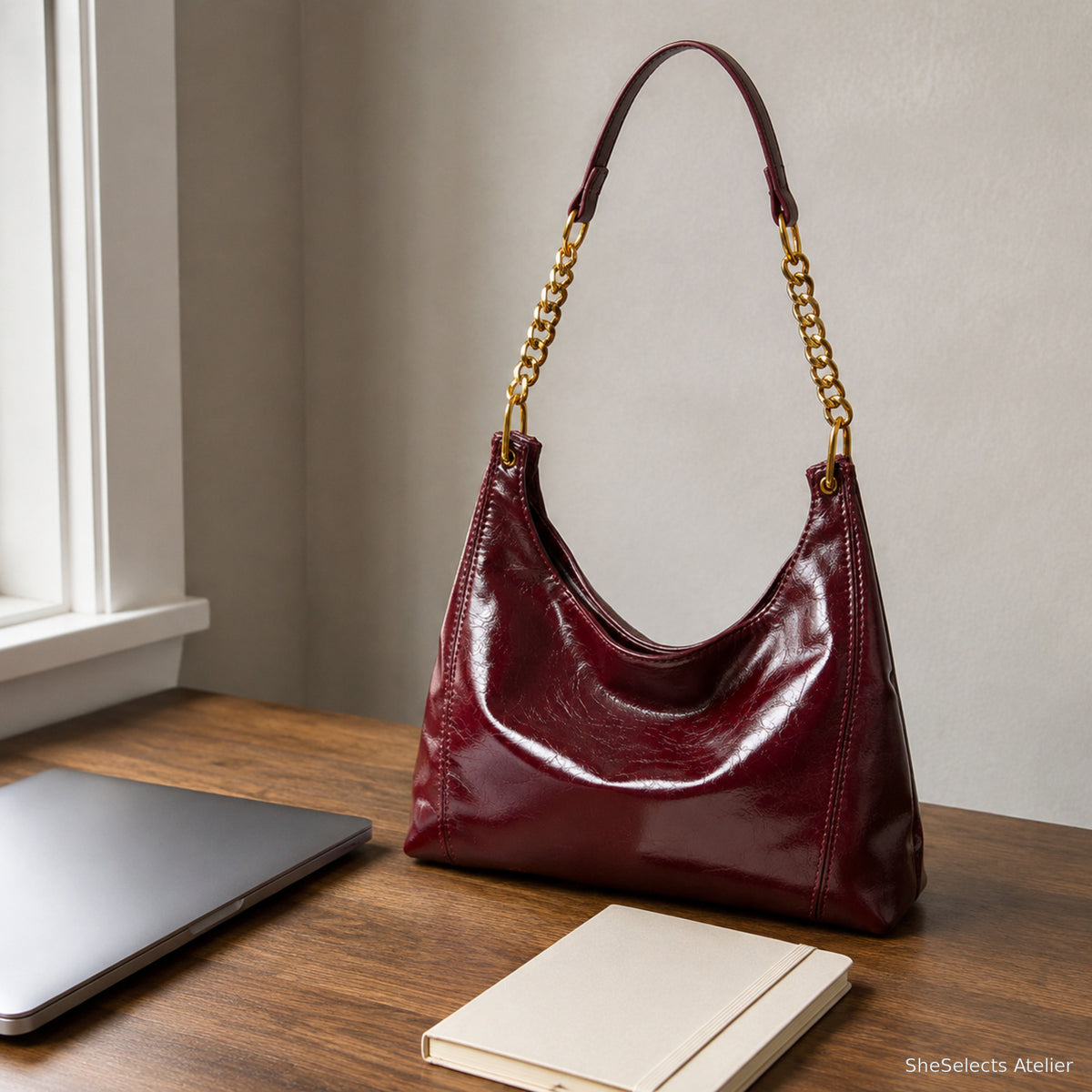 Burgundy glossy hobo bag styled for a workday