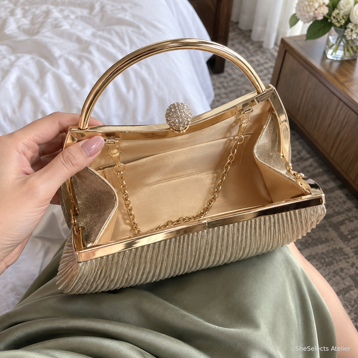 Open Celestine Gold bag showing satin lining pockets and chain