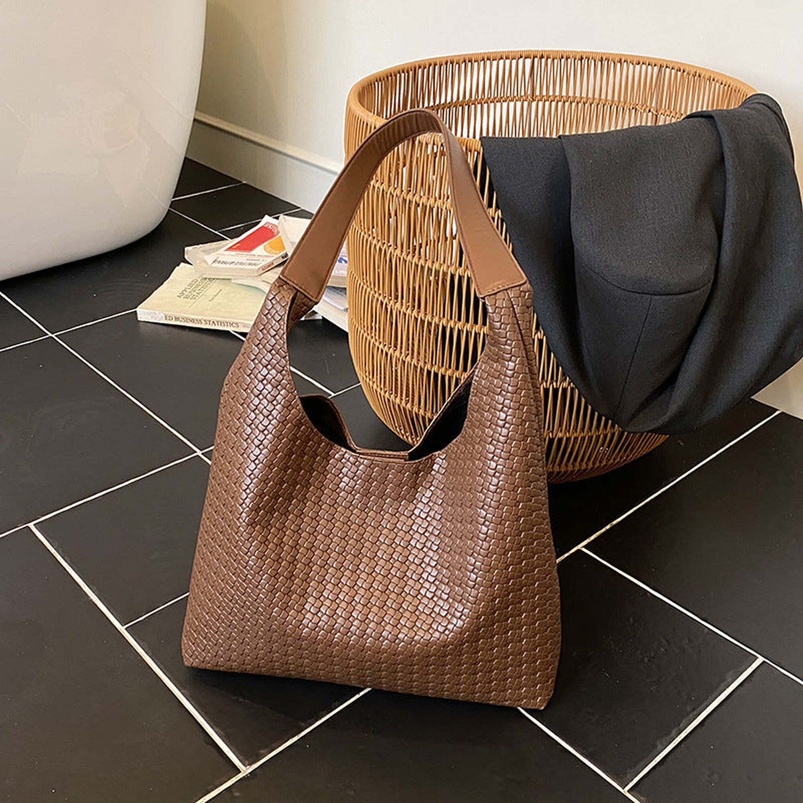 Light brown woven vegan leather hobo bag in a warm home setting
