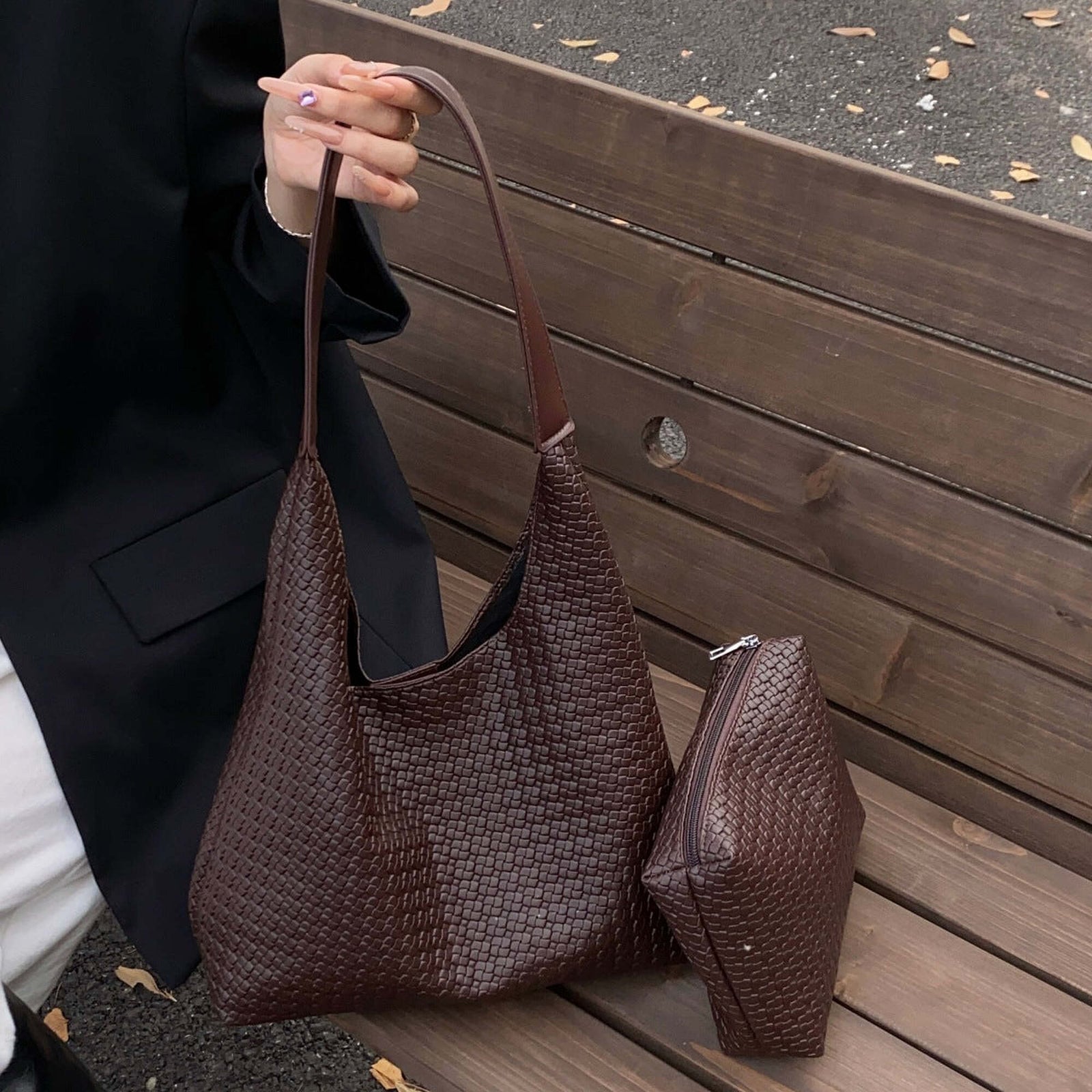 Brown woven hobo bag carried with the exact matching tapered wedge zip pouch