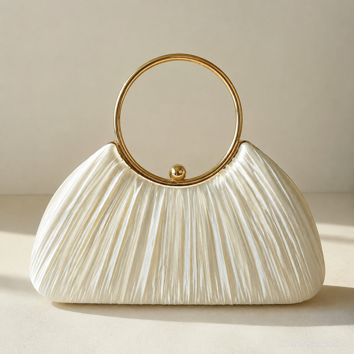 Pearl ivory pleated satin evening clutch with polished gold ring handle and ball clasp