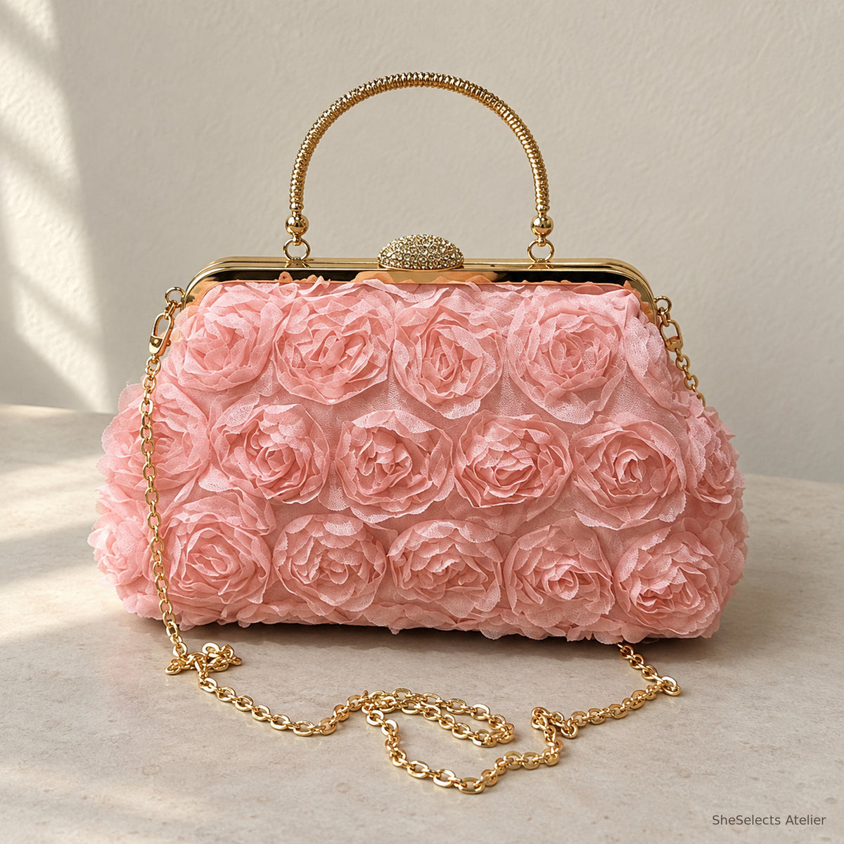 Blush pink floral rosette handbag with gold handle and chain, front view