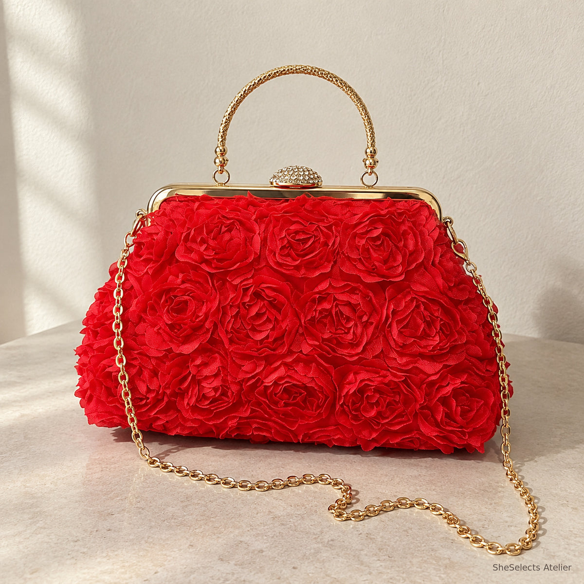 Red floral rosette handbag with gold handle and chain, front view