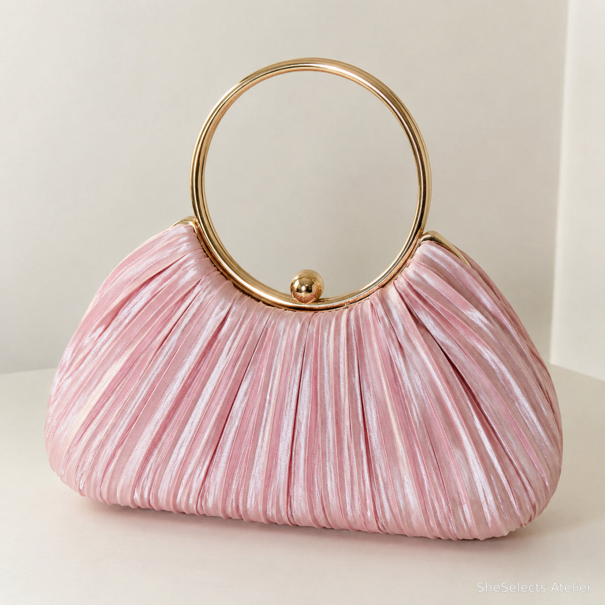 Rose pink pleated satin evening purse with round gold handle