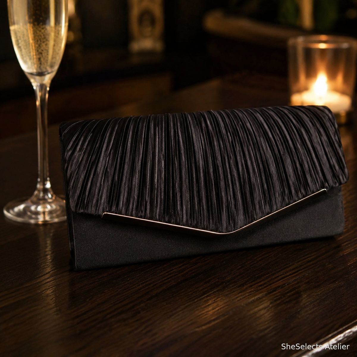 Black pleated satin envelope clutch styled for an evening event