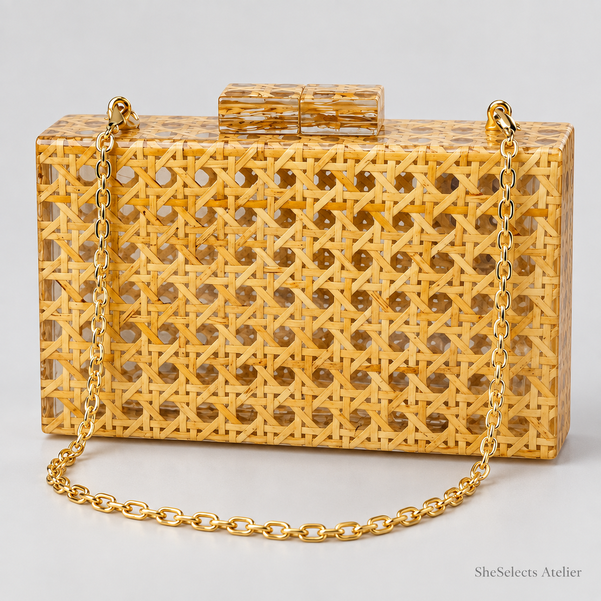 Aurelia woven acrylic evening bag with gold-tone chain on a light grey background
