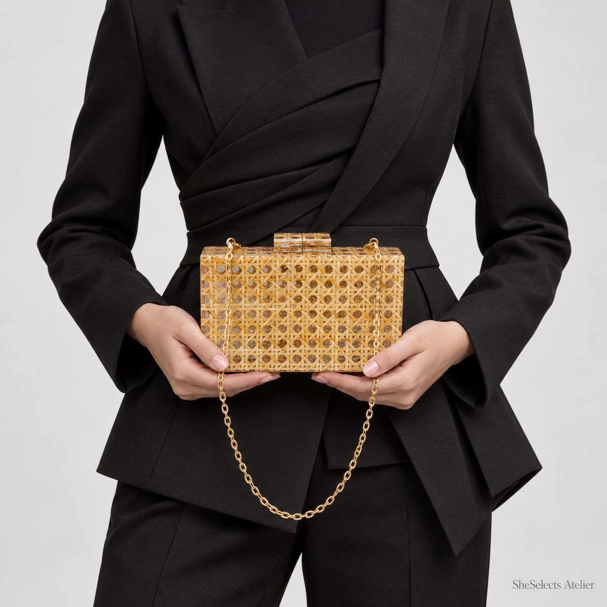 Aurelia evening bag held at the waist with a sculptural black suit